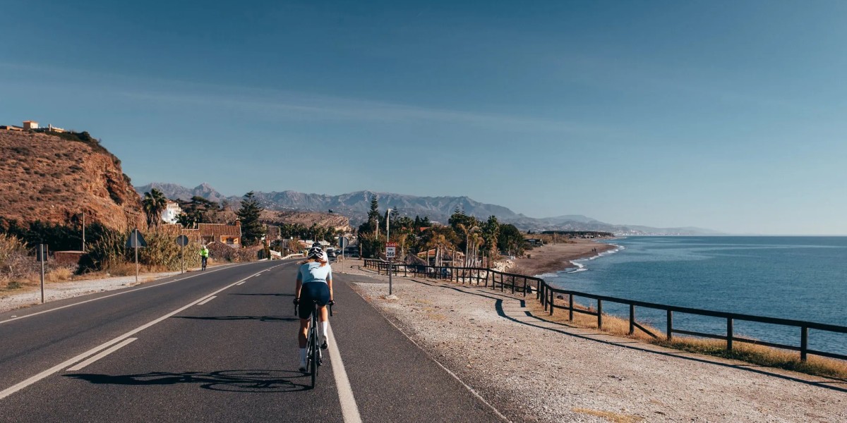 Cyclist on Spain’s Costa del Sol riding a coastal road with Mediterranean views